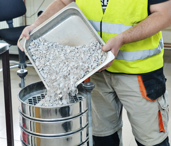 Sifting concrete, part of the aggregate testing process