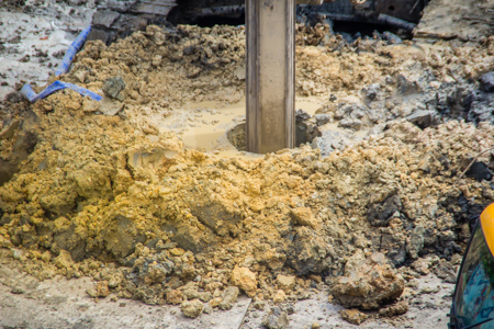 Drilling into mud for collecting soil samples